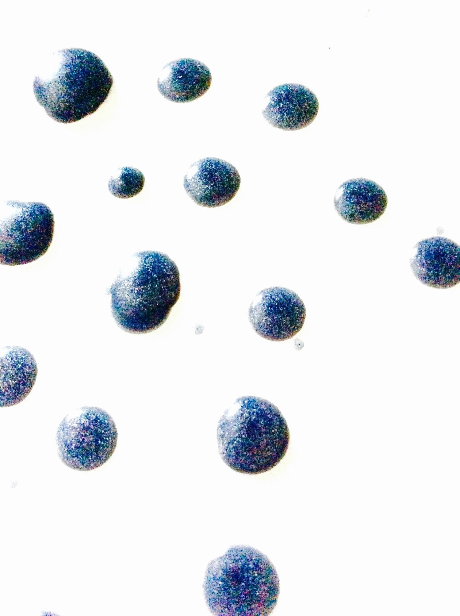 Blue glittery bubbles on a white background