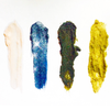Four different colored makeup swatches on a white background