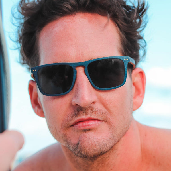 Joycoast Blu Wayfinder wooden sunglasses with blue polarized lenses on model