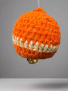 Close-up of organic wool crochet bulb ornament showing hand-crocheted texture and bell detail
