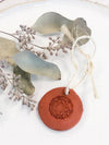 Handcrafted terra cotta essential oil diffuser with twine loop by Butter Me Up Organics