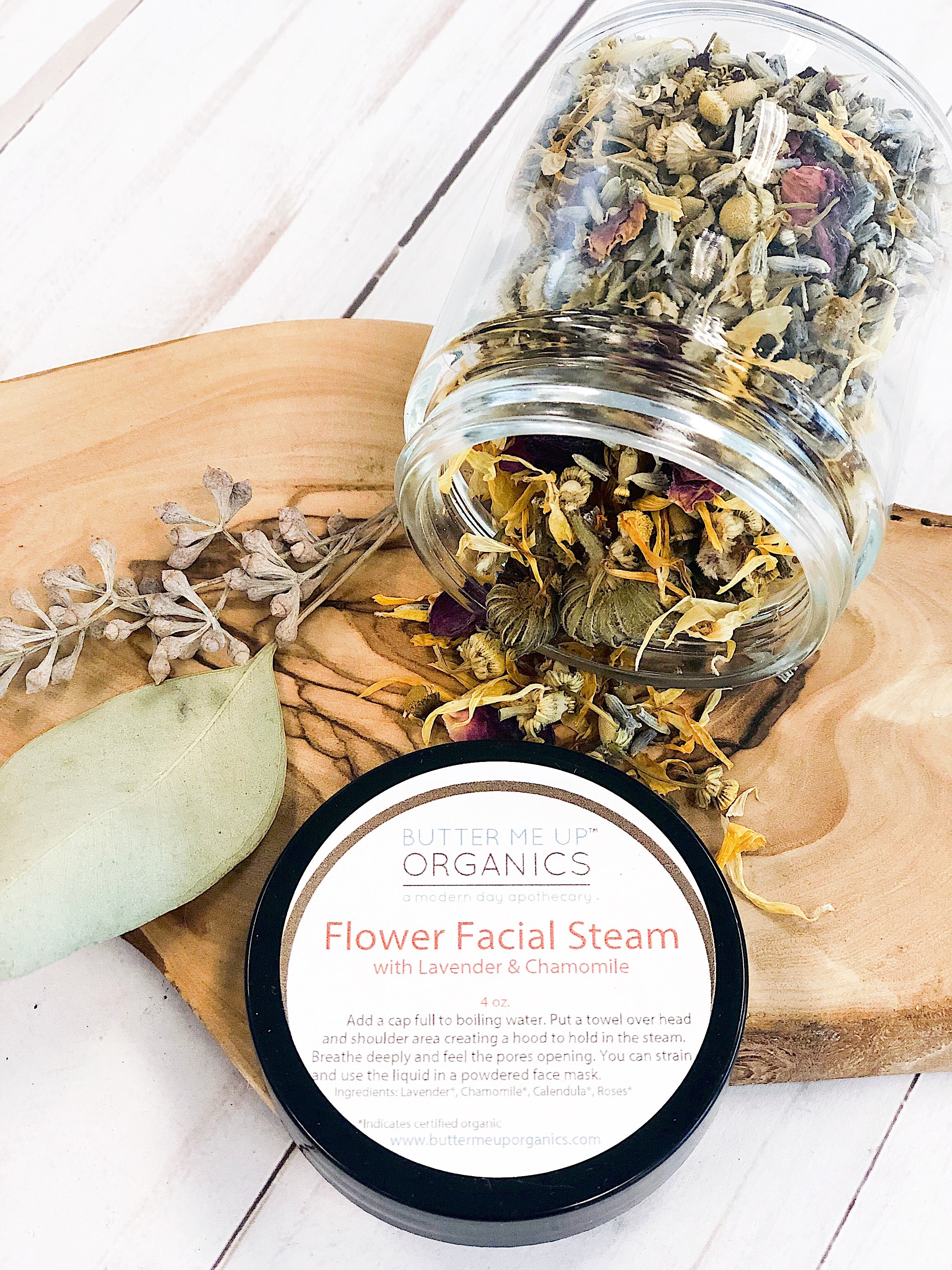 Flat lay of Butter Me Up Organics Calming Herbal Facial Steam jar surrounded by dried herbs and flowers