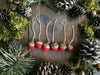 Close view of Amanita Red felted wool acorn ornaments showing handmade wool texture