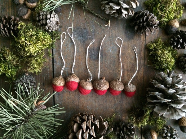 Close view of Amanita Red felted wool acorn ornaments showing handmade wool texture