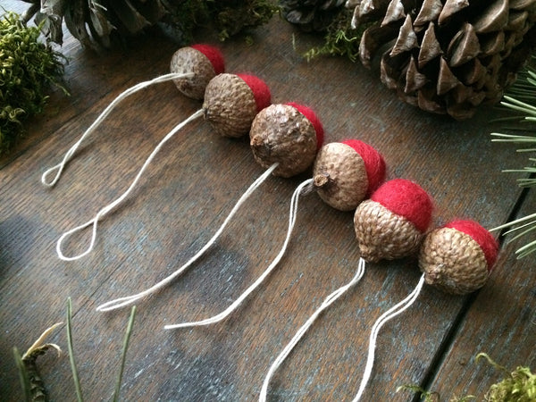 Felted wool acorn ornaments in varied sizes, part of a set of six
