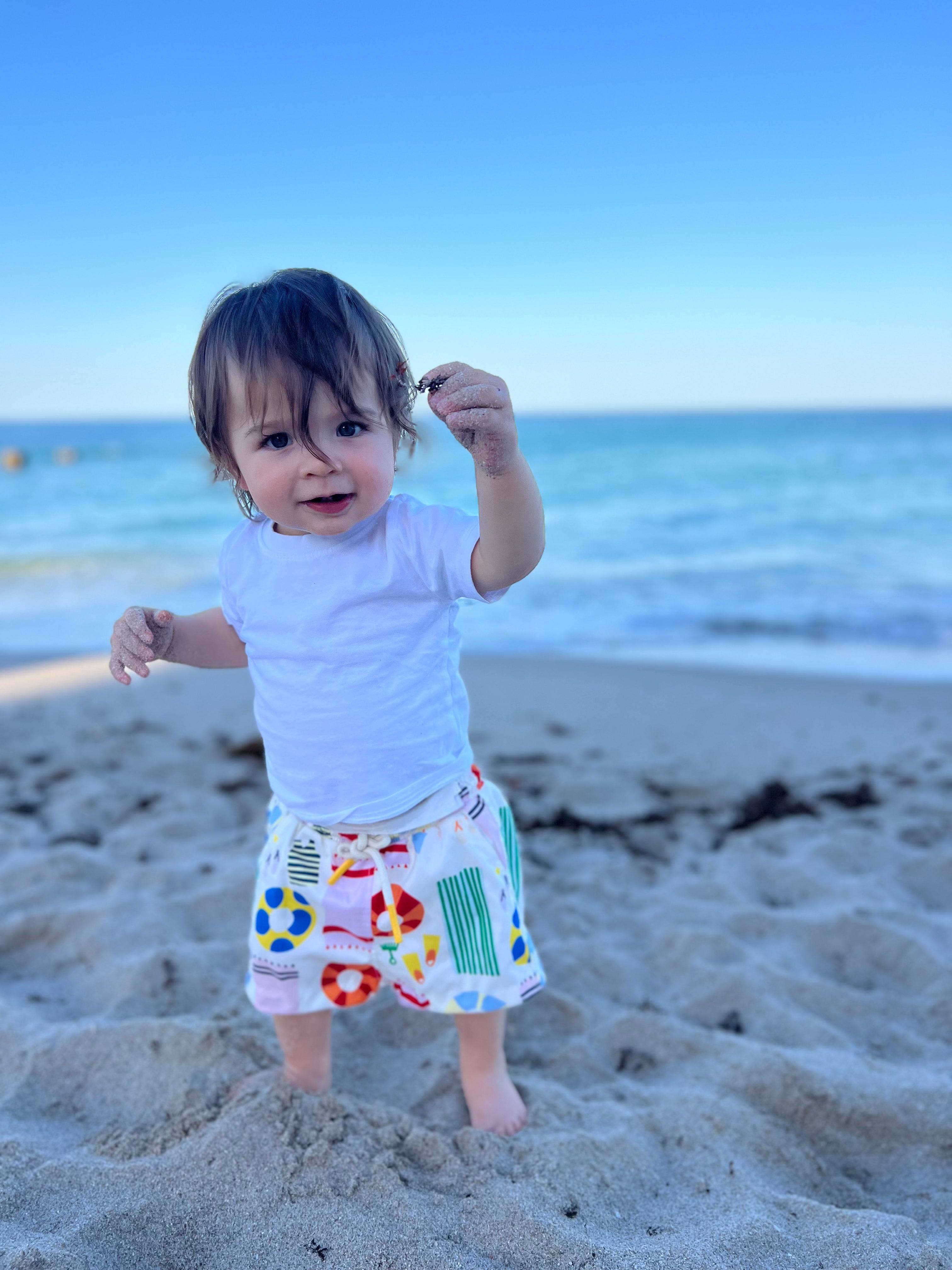 Child on a beach with ocean in the background