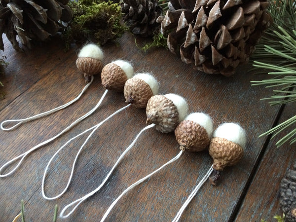 Add a touch of nature to your holiday decor with this adorable, hand-felted wool acorn ornament. Perfect for Christmas trees, wreaths, or as a gift.