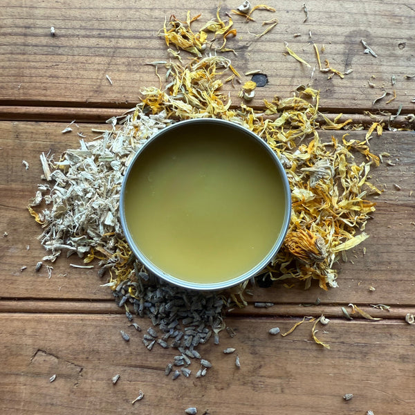 Close-up of Apotheke DuJardin Nipple Salve showing natural herbal salve texture, made with beeswax and geranium essential oil