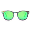 Sunglasses with green lenses and a patterned frame on a white background