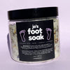 Jo's Flower and Herb Foot Soak in a glass jar with organic lavender, calendula, and blue cornflower botanicals