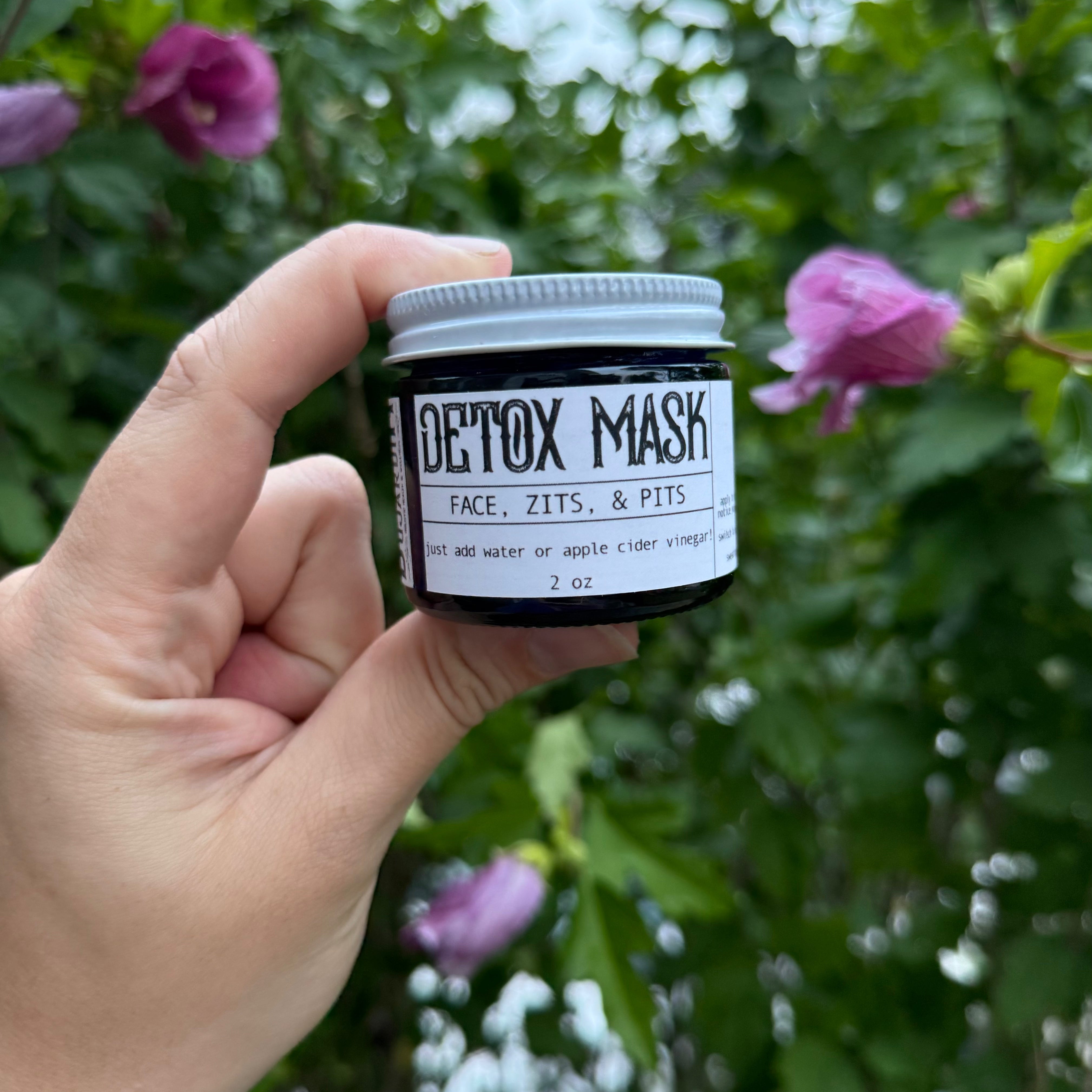 Apotheke DuJardin clay detox mask powder in a 2 oz jar on a natural surface