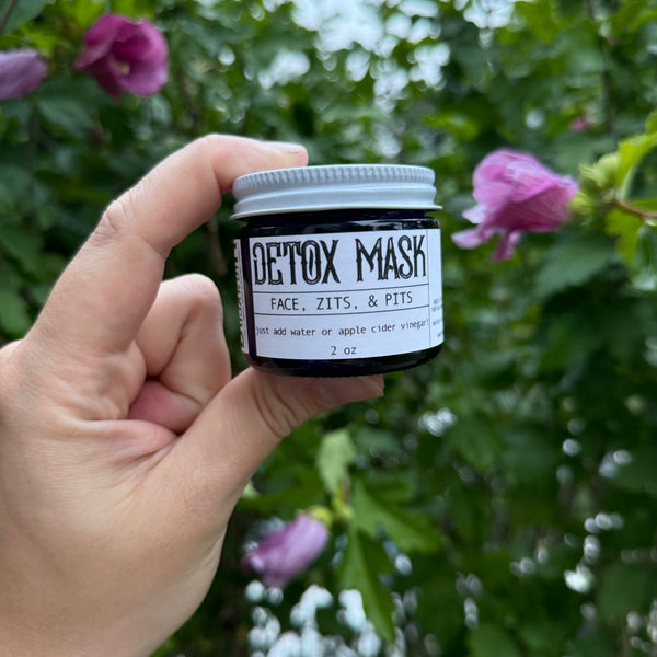 Apotheke DuJardin clay detox mask powder in a 2 oz jar on a natural surface