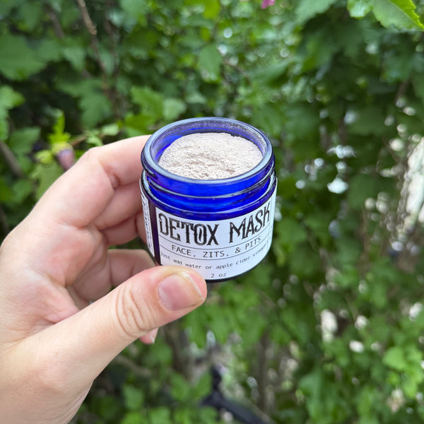 Clay detox mask being applied to face for skin-clearing and pore-tightening