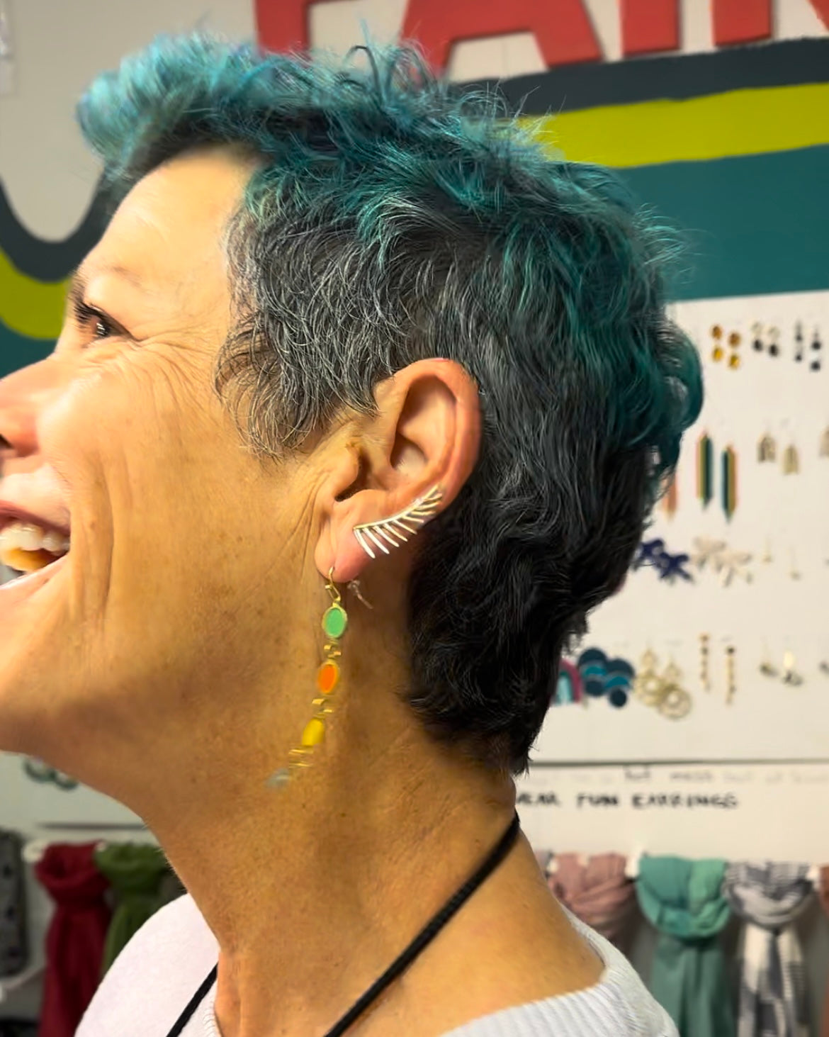 Close-up of Black Swan Winged Earrings worn as an ear climber, nickel-free recycled brass