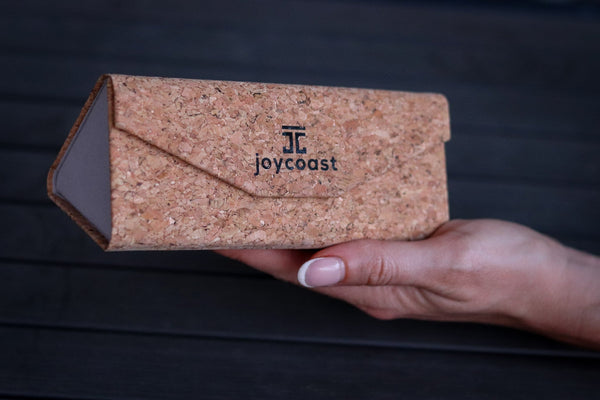 Joycoast cork folding sunglasses case open showing microfiber lining and motivational mantra