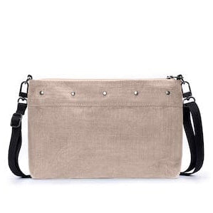 Beige handbag with black strap on a white background