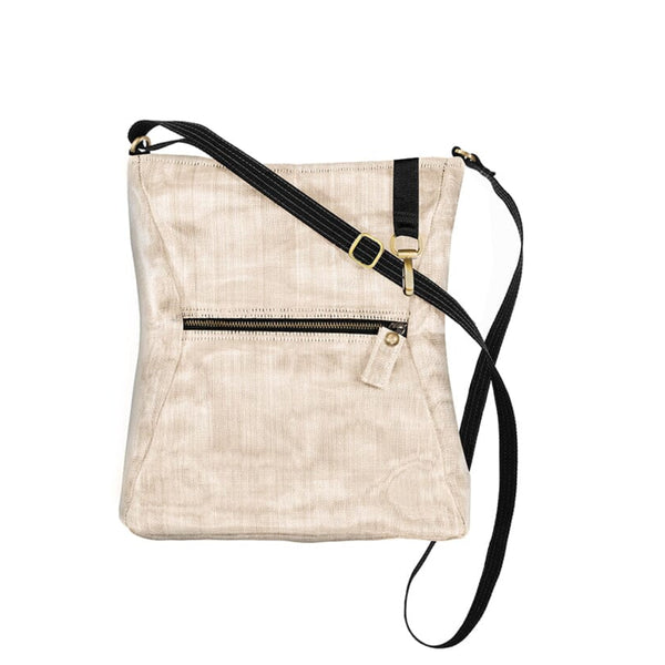 Beige crossbody bag with black strap on a white background
