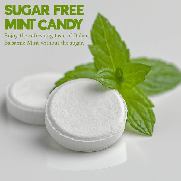Sugar-free mint candy with a sprig of mint on a light background