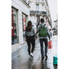 Two people walking down a city street on a rainy day.