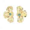 In Bloom stud earrings by Fair Anita — flower-shaped recycled brass studs with teal stone accent