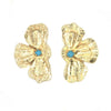 Gold flower-shaped earrings with turquoise centers on a white background