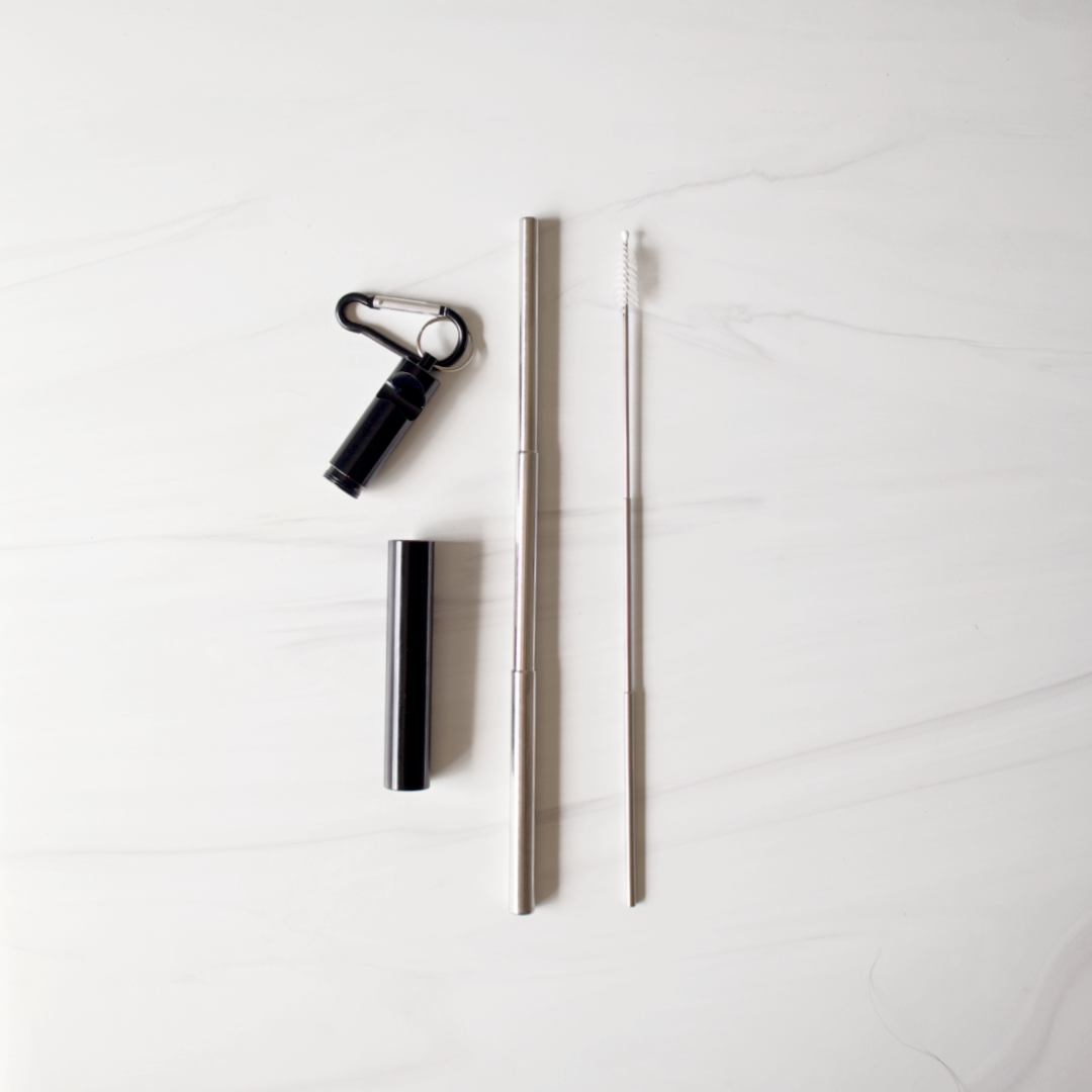 Set of black and silver travel accessories on a white background