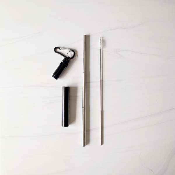 Set of black and silver travel accessories on a white background