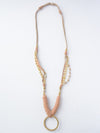 Close-up of Fair Anita Leather Loop Necklace showing recycled bullet casing and brass construction