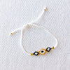 Beaded bracelet with geometric pattern on a light gray background