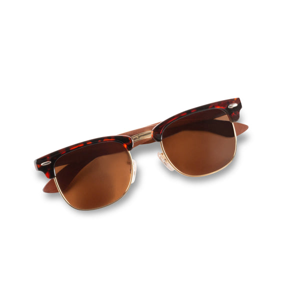 Person wearing Joycoast Malcolm walnut wooden sunglasses outdoors in natural light
