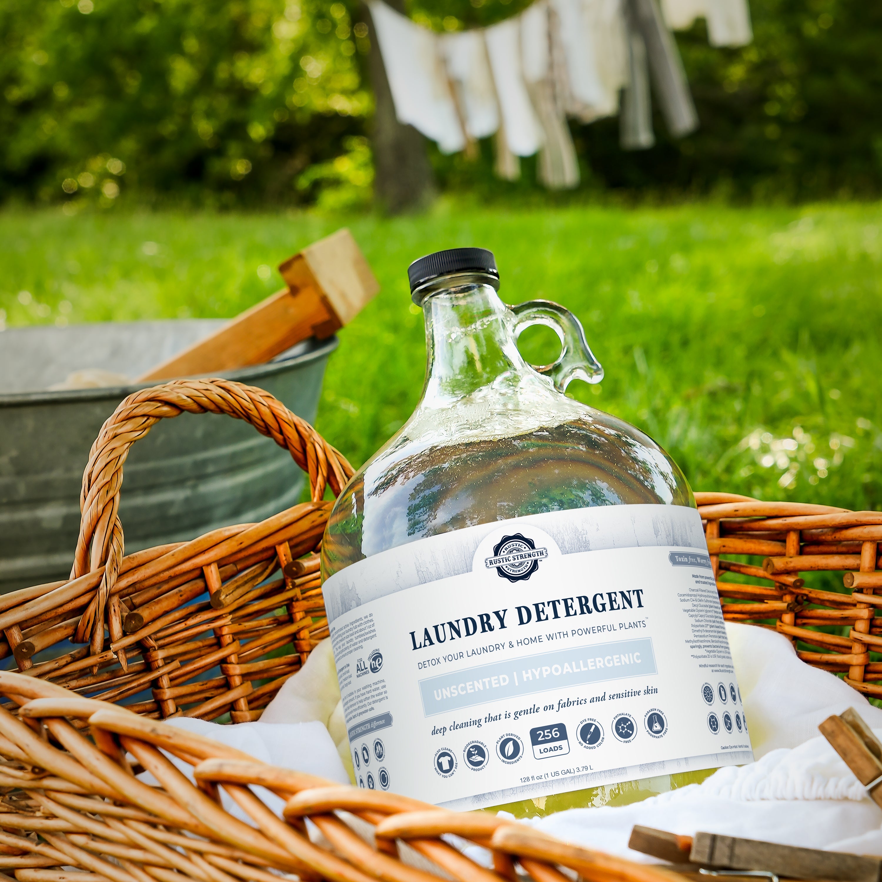 Half-gallon jug of Rustic Strength natural laundry detergent displayed in a laundry basket