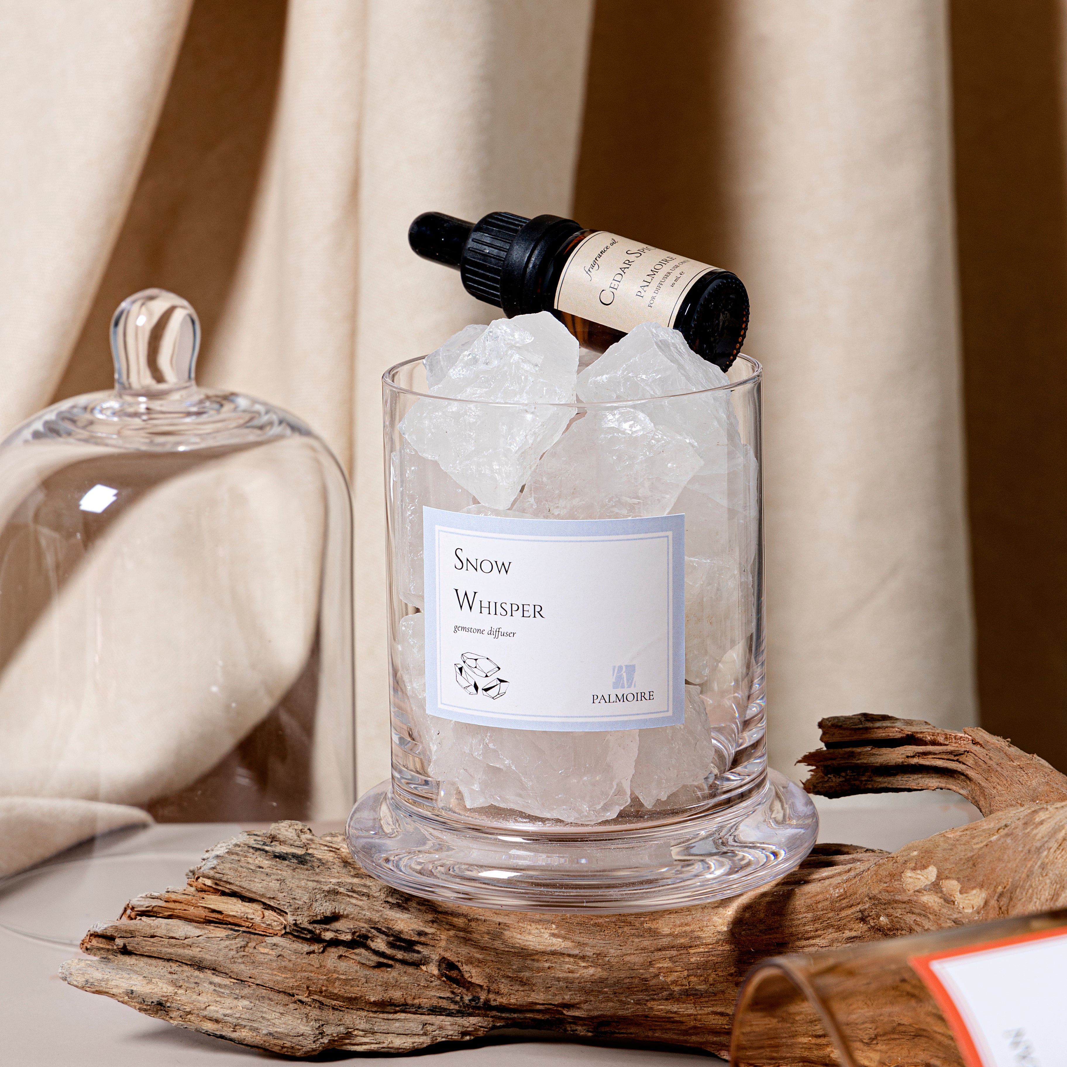 Glass container with ice and 'Snow Whisper' label on a wooden surface with a blurred background