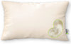 Beige pillow with a heart-shaped cutout revealing white stuffing on a white background