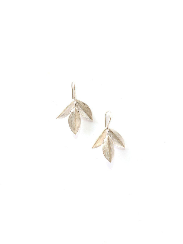Woman wearing Fair Anita silver leaf cluster earrings, nature-inspired jewellery for everyday wear
