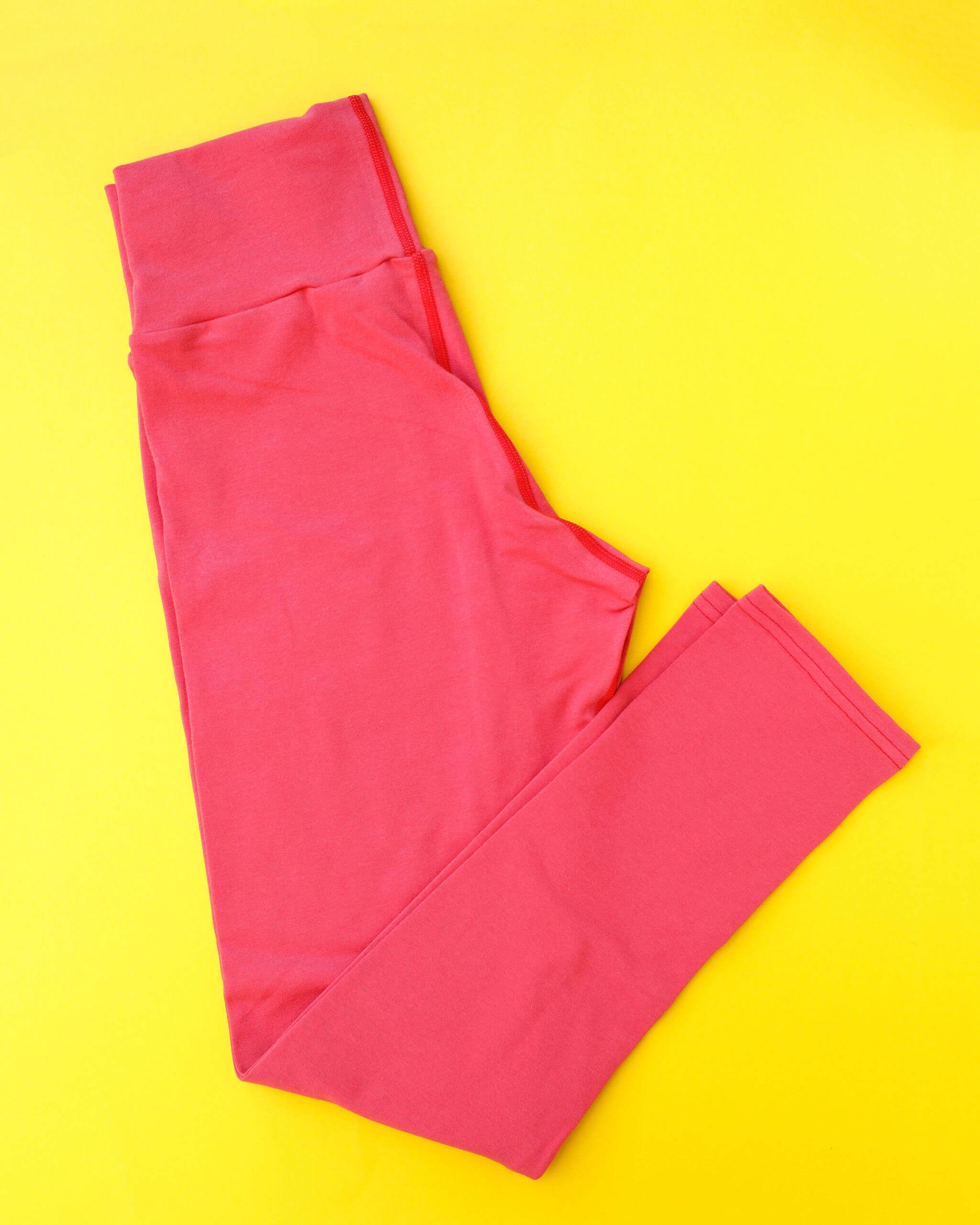 Close-up of Thunderpants Pomegranate Punch leggings showing dusty coral-pink colour and fabric texture