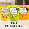 Three packages of Lovely Ginger Chews with different flavors on a light background.