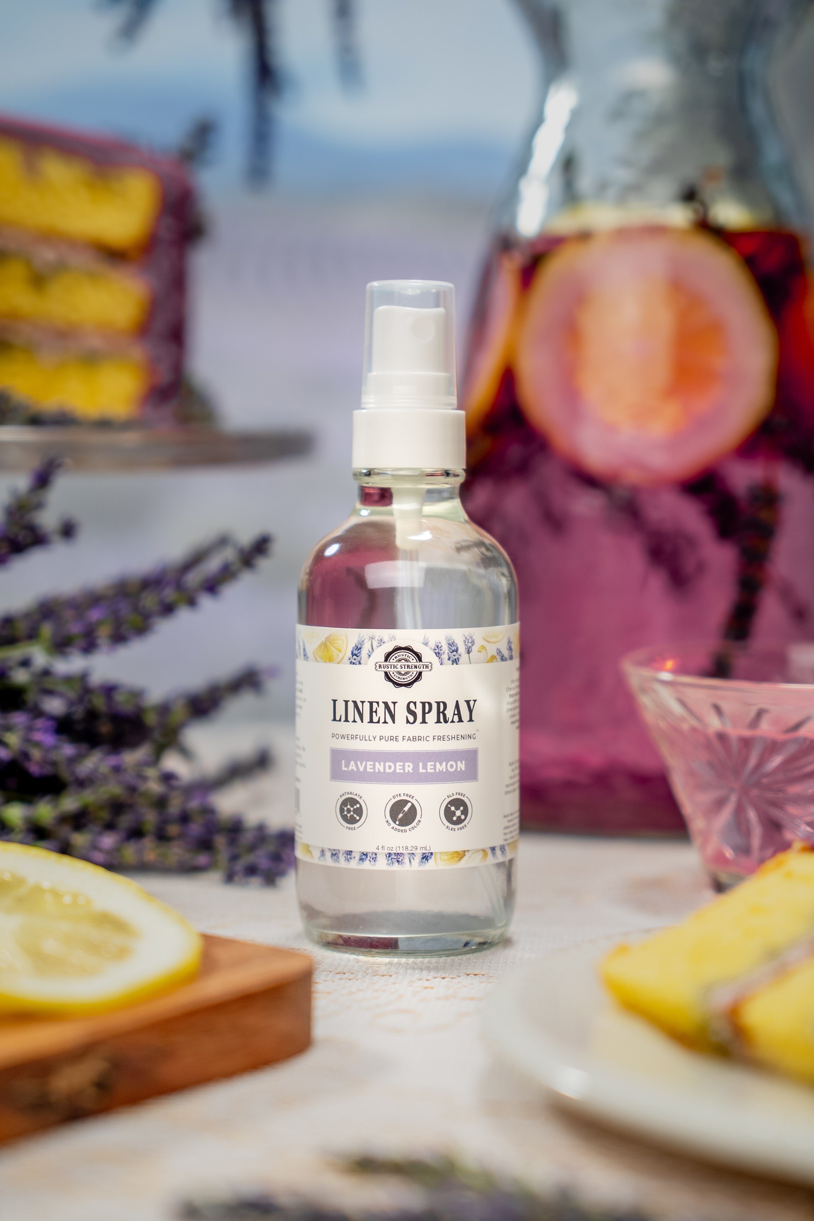 Rustic Strength linen spray styled on a bedroom nightstand with soft linens