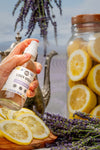 Rustic Strength natural linen spray being spritzed onto white bedding