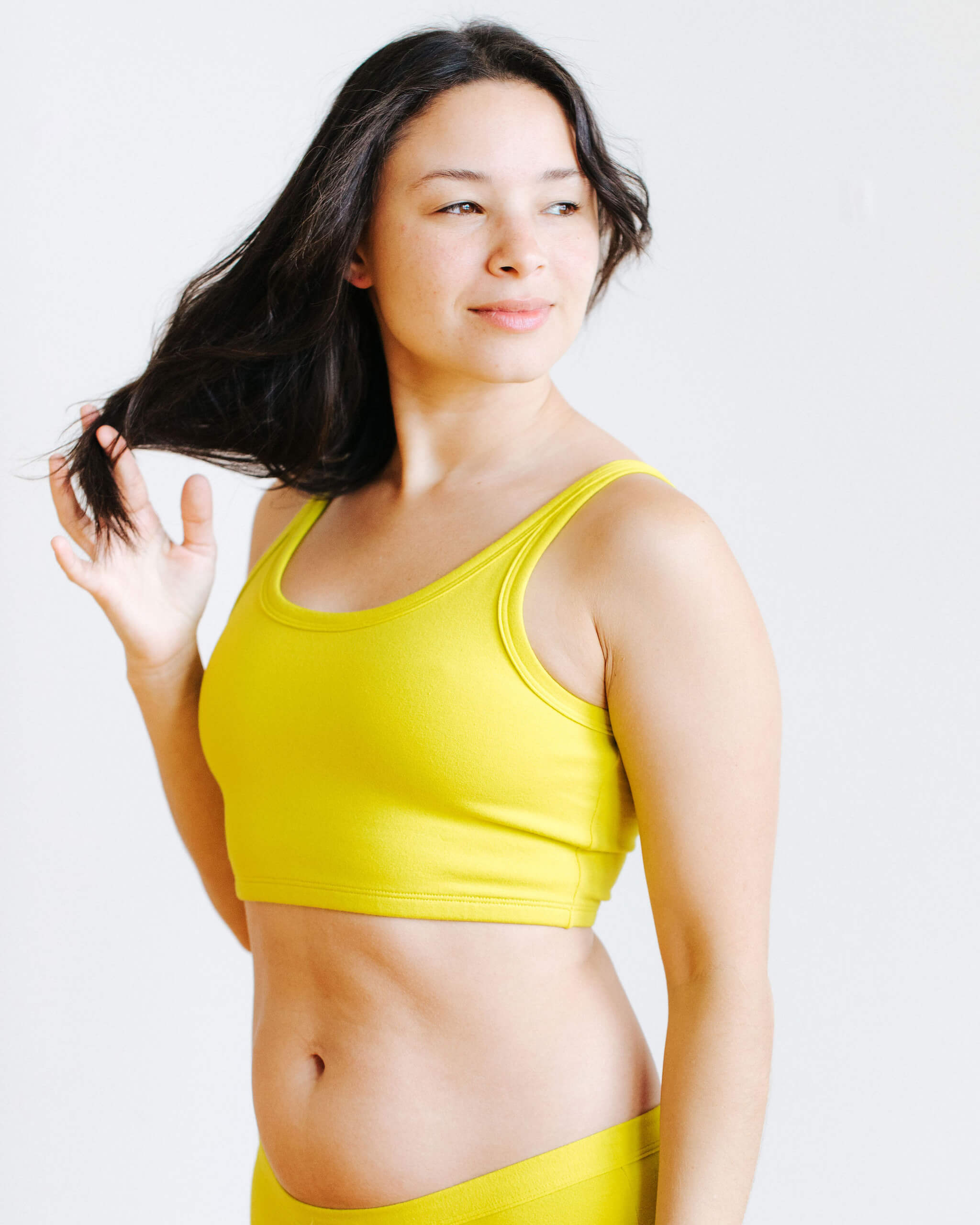 Side view of model wearing the Star Fruit Longline Bra by Thunderpants USA