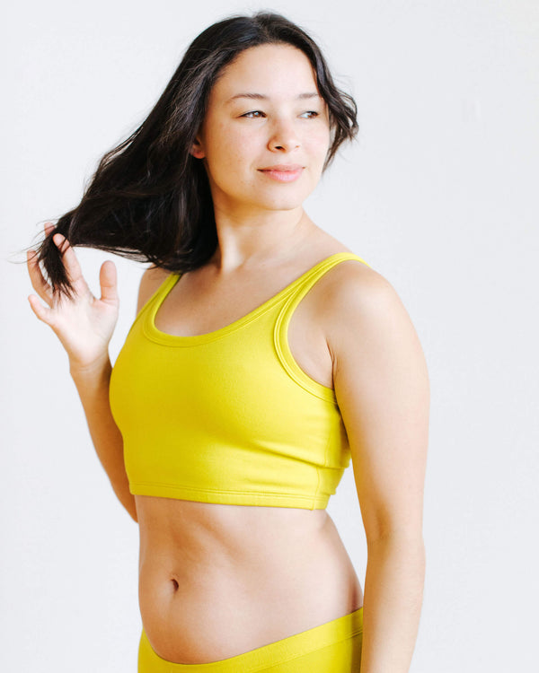 Side view of model wearing the Star Fruit Longline Bra by Thunderpants USA