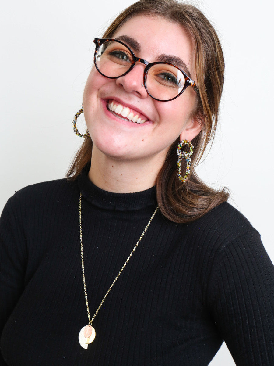 Close-up of vibrant confetti-style beaded loop earrings by Fair Anita