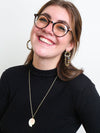 Close-up of vibrant confetti-style beaded loop earrings by Fair Anita
