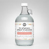 Clear spray cleaner bottle with a label on a white background