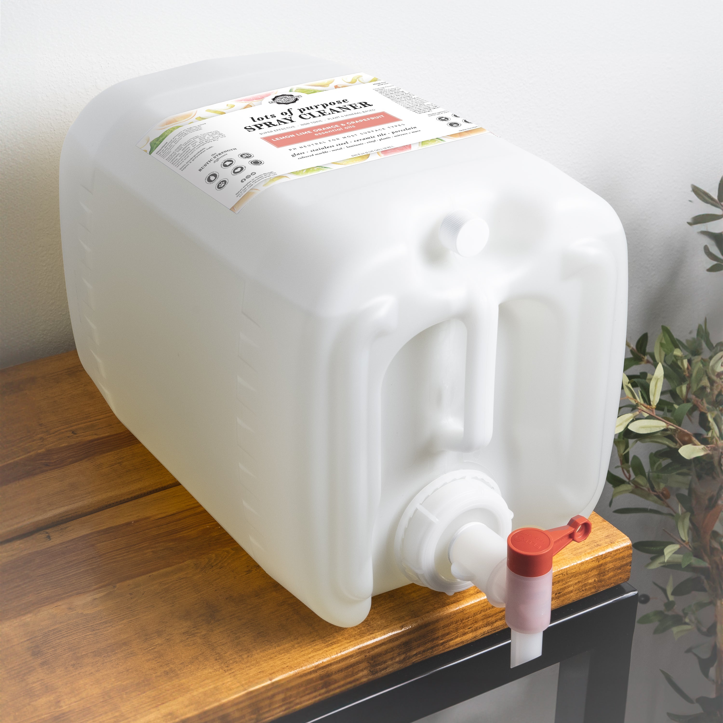 White container with a red valve on a wooden surface