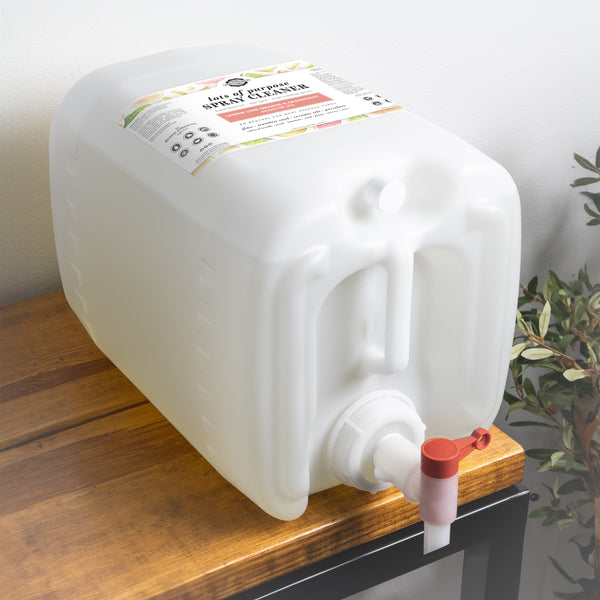 White container with a red valve on a wooden surface