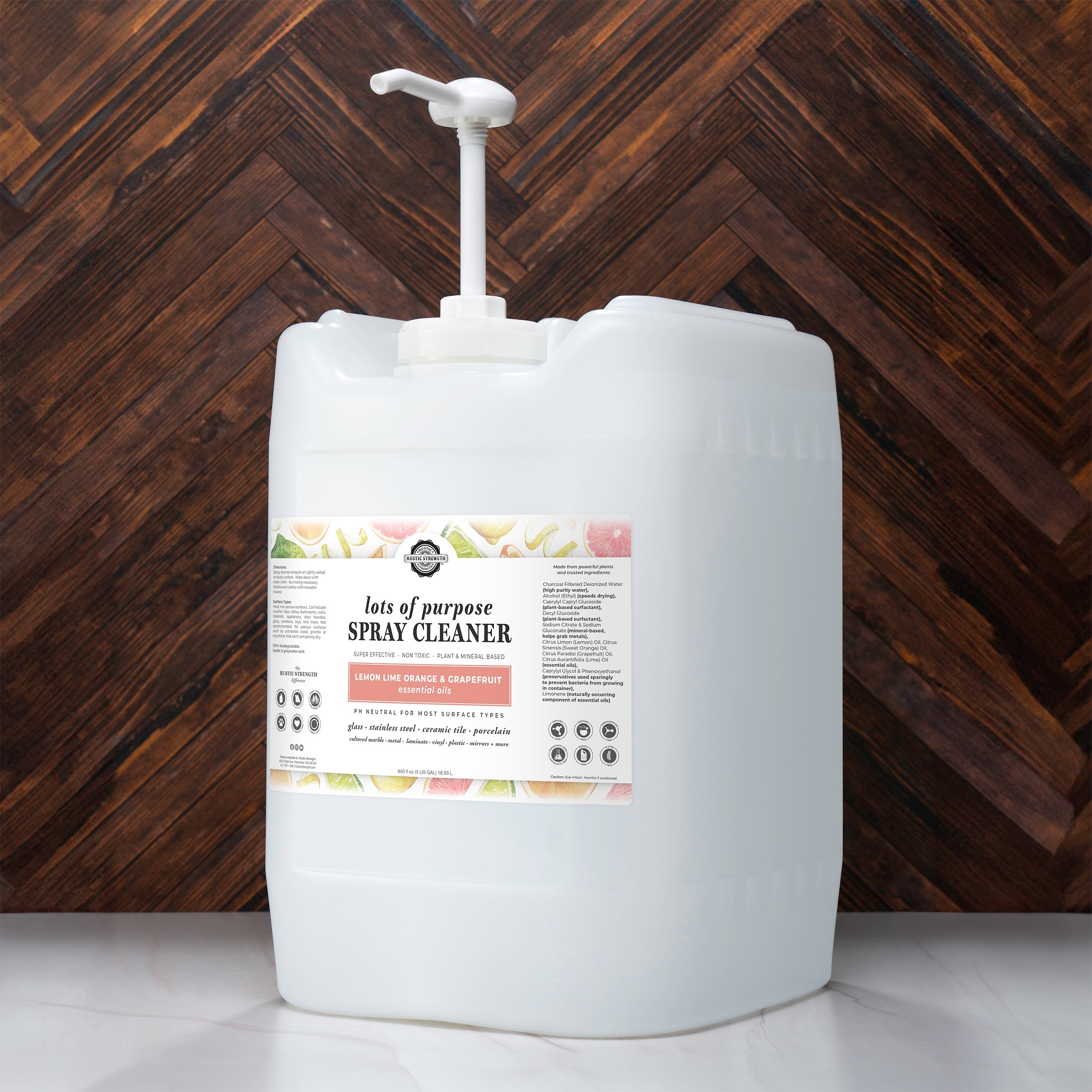 Large white container of spray cleaner with a label on a wooden background