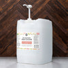 Large white container of spray cleaner with a label on a wooden background