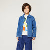 Child wearing the Mon Coeur Denim Barn Jacket as a layering piece, made in Portugal