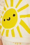 Close-up of a yellow sun with a face on a white background