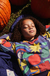 Close-up of Mon Coeur kids sweatshirt showing multicolor shape pattern and ribbed neckline detail